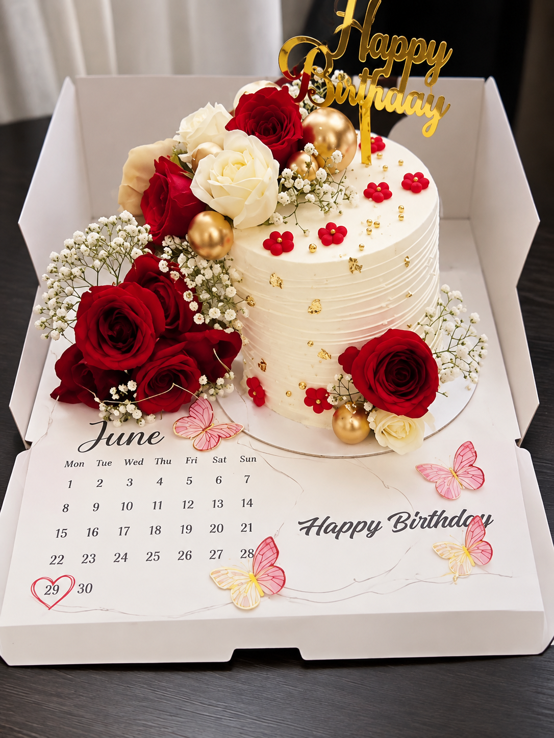 Birthday cake inside an open box with a printed calendar and circled birthday date